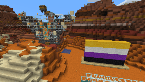 At the foot of the mesa, one can see a nonbinary flag and a smelting machine.